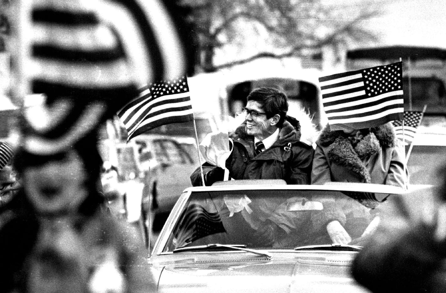 February 15, 1981 L. Bruce Laingen smiled as his parade moved through the streets of Odlin, Minn., Saturday. His wife, Penne, was hidden behind an American flag. Regene Radniecki, Minneapolis Star Tribune