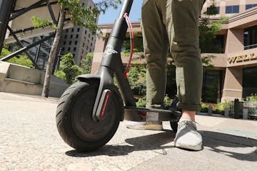 A person rides an electric scooter