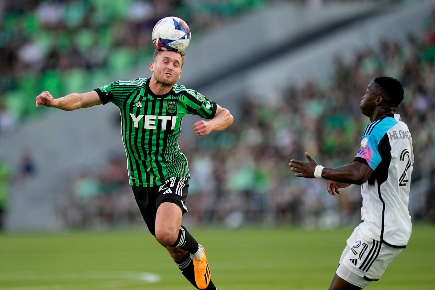 Austin FC defender Adam Lundqvist, left, passes the ball past Minnesota United forward Bongokuhle Hlongwane during the first half of an MLS soccer match Wednesday, May 31, 2023, in Austin, Texas. (AP Photo/Eric Gay)