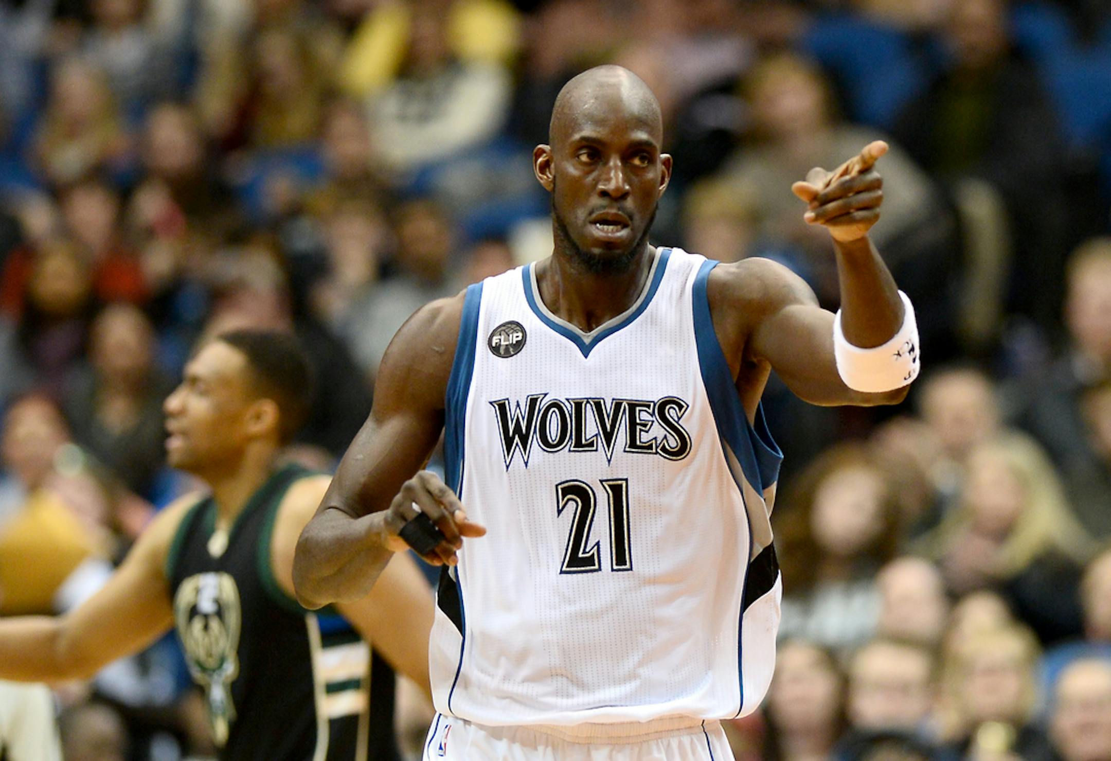Minnesota Timberwolves forward Kevin Garnett (21) gestured to guard Andrew Wiggins (22) after Wiggins hit a 2-point jump shot in the third quarter against the Milwaukee Bucks on Jan. 2, 2016, at Target Center in Minneapolis.