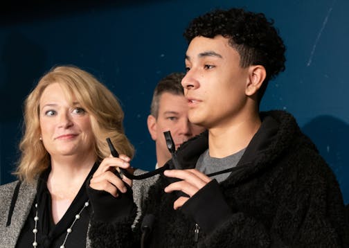 Yasiel Santiago-Castillo, a senior at Henry Sibley High School, held a vaping device disguised as a hoodie drawstring. On his left is Rep. Laurie Halverson, D-Eagan. Joined by students from Henry Sibley High School, Minnesota House DFL lawmakers introduced a new comprehensive plan to prevent youth tobacco use on Monday, Oct. 28.