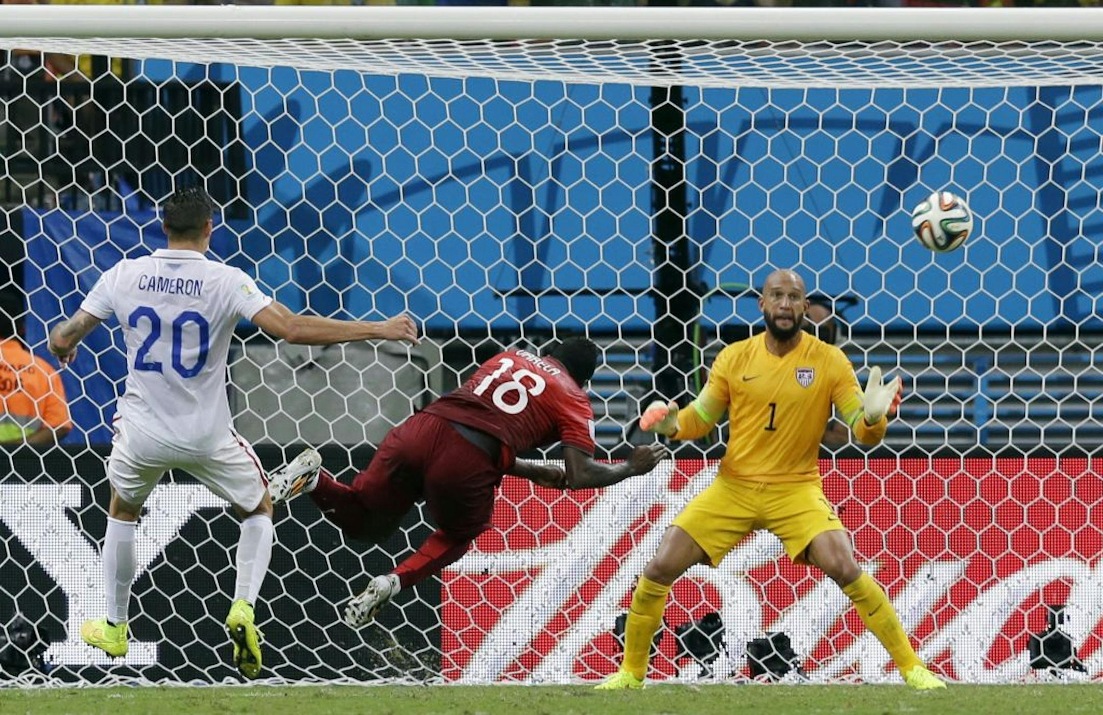 Portugal's Silvestre Varela heads the ball past United States' goalkeeper Tim Howard to score his side's second goal and tie the game 2-2 during the group G World Cup soccer match between the USA and Portugal at the Arena da Amazonia in Manaus, Brazil, Sunday, June 22, 2014.