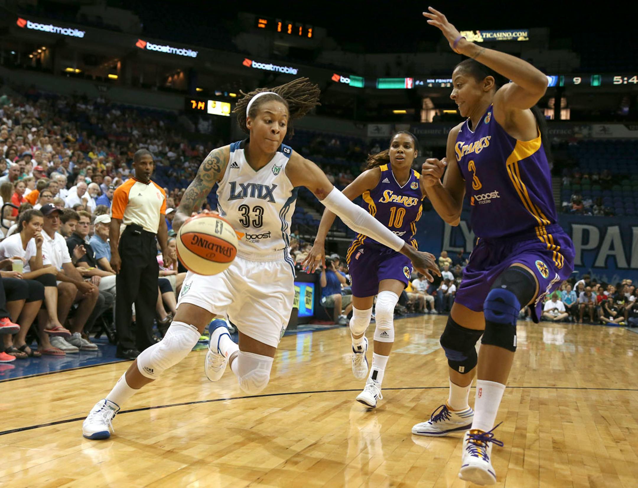 Seimone Augustus, with the Sparks' Candace Parker defending, drove to the basket during the first half at Target Center on Wednesday, September 4, 2013.