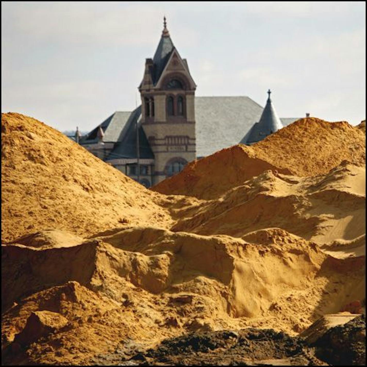 A 50,000-ton pile of sand that was called "Mt. Frac" in downtown Winona. The Winona County Law Enforcement Center is in background.