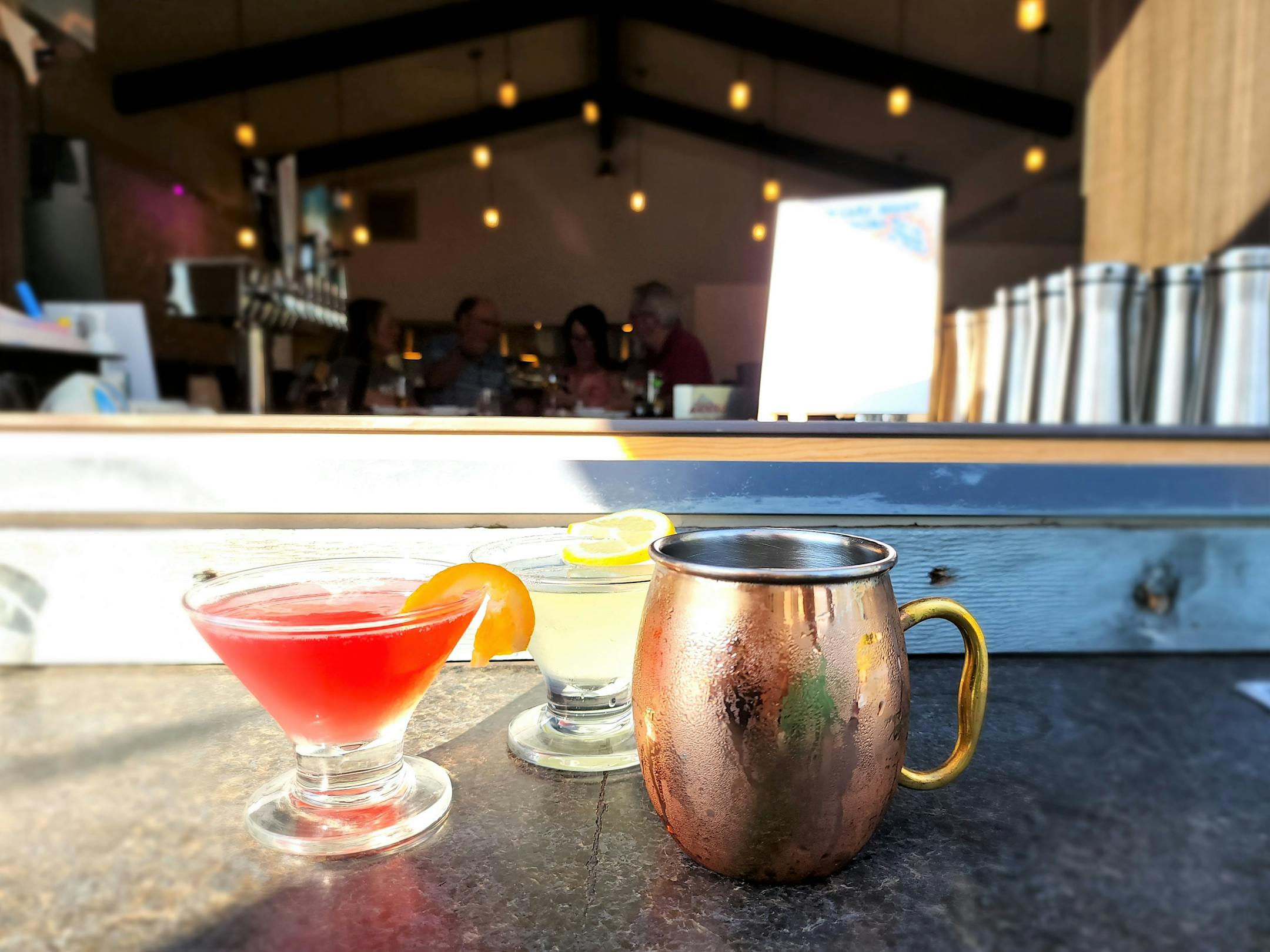 three cocktails on a bar