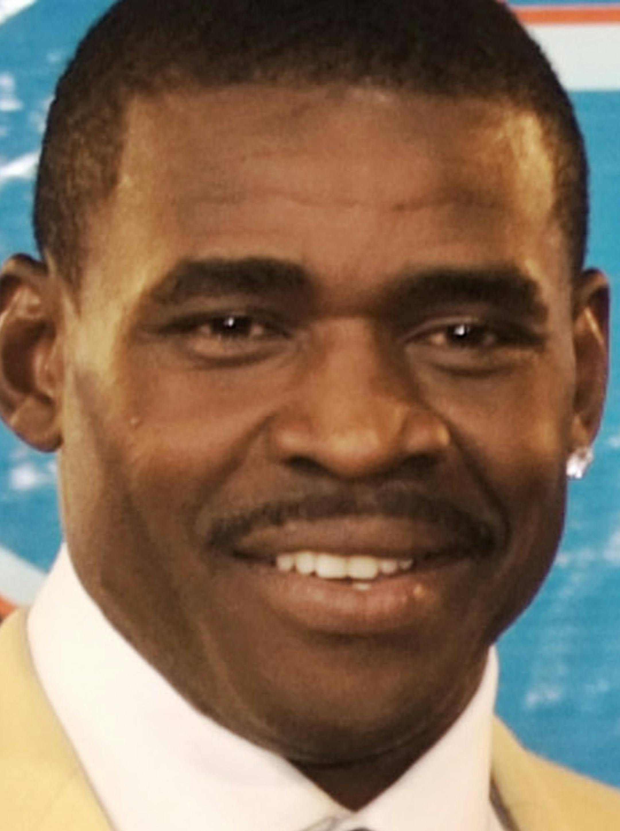 ** FILE ** This is an Aug. 4, 2007 file photo showing Michael Irvin at the Pro Football Hall of Fame during induction ceremonies, in Canton, Ohio. Irvin says he calmly chatted with a gunman in another vehicle after the armed passenger turned out to be a Dallas Cowboys fan, Monday night Jan. 12, 2009 in Dallas. Irvin, who was not harmed, says he was "very afraid." (AP Photo/Phil Long, File)