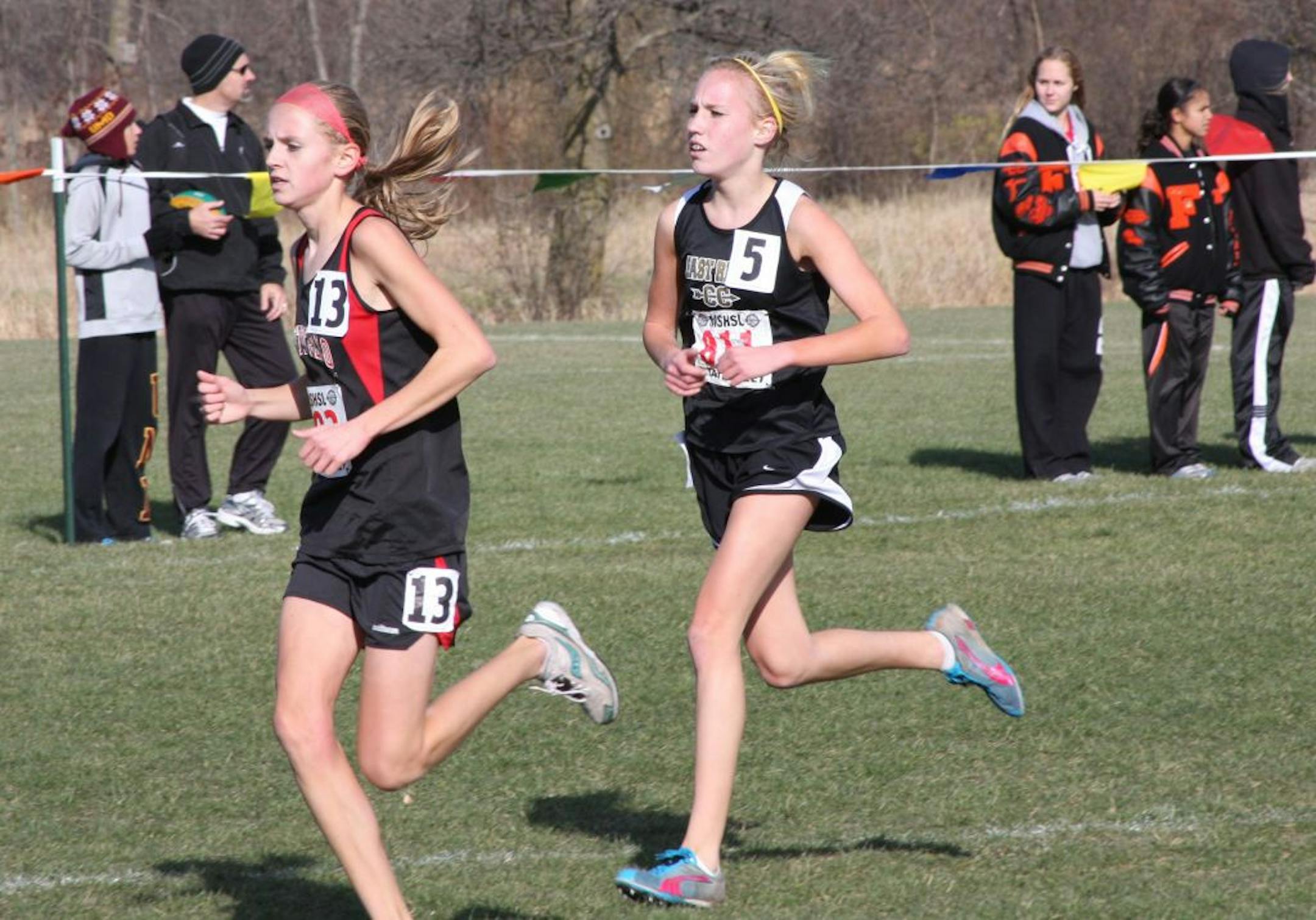Bailey Ness, East Ridge cross-country runner, trails Amber Siedenkranz from Monticello.