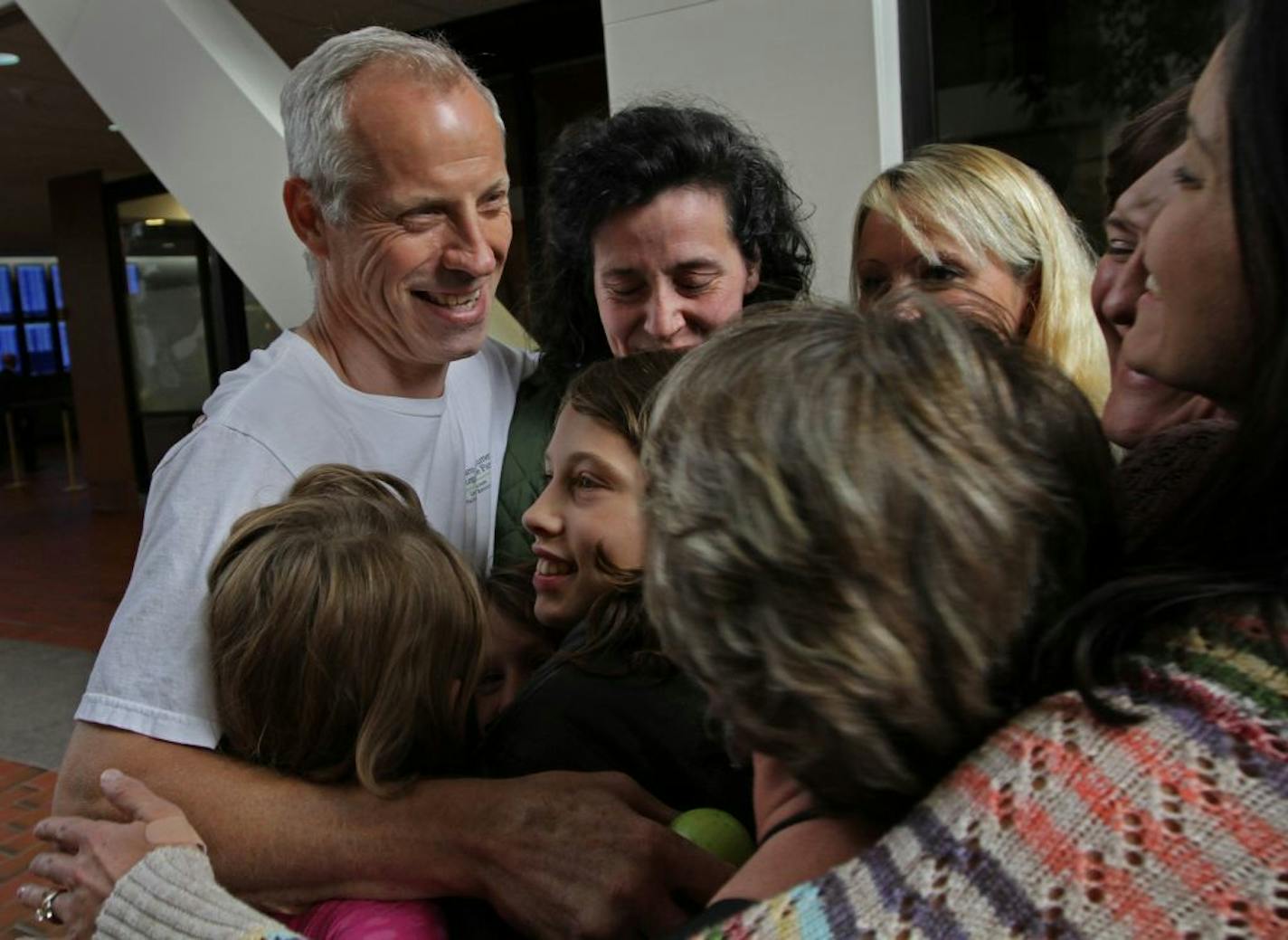 Alvin Schlangen, left, got a hug from his supporters after he was found not guilty of selling unpasteurized milk and other charges.