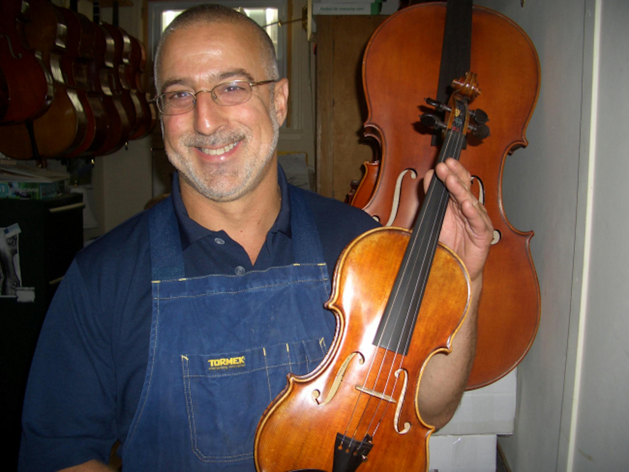 Andy Fein of Fein Stringed Instruments, 52, St. Paul. He's a luthier -- he makes and repairs stringed instruments. That Job subject. August 2008 photo.