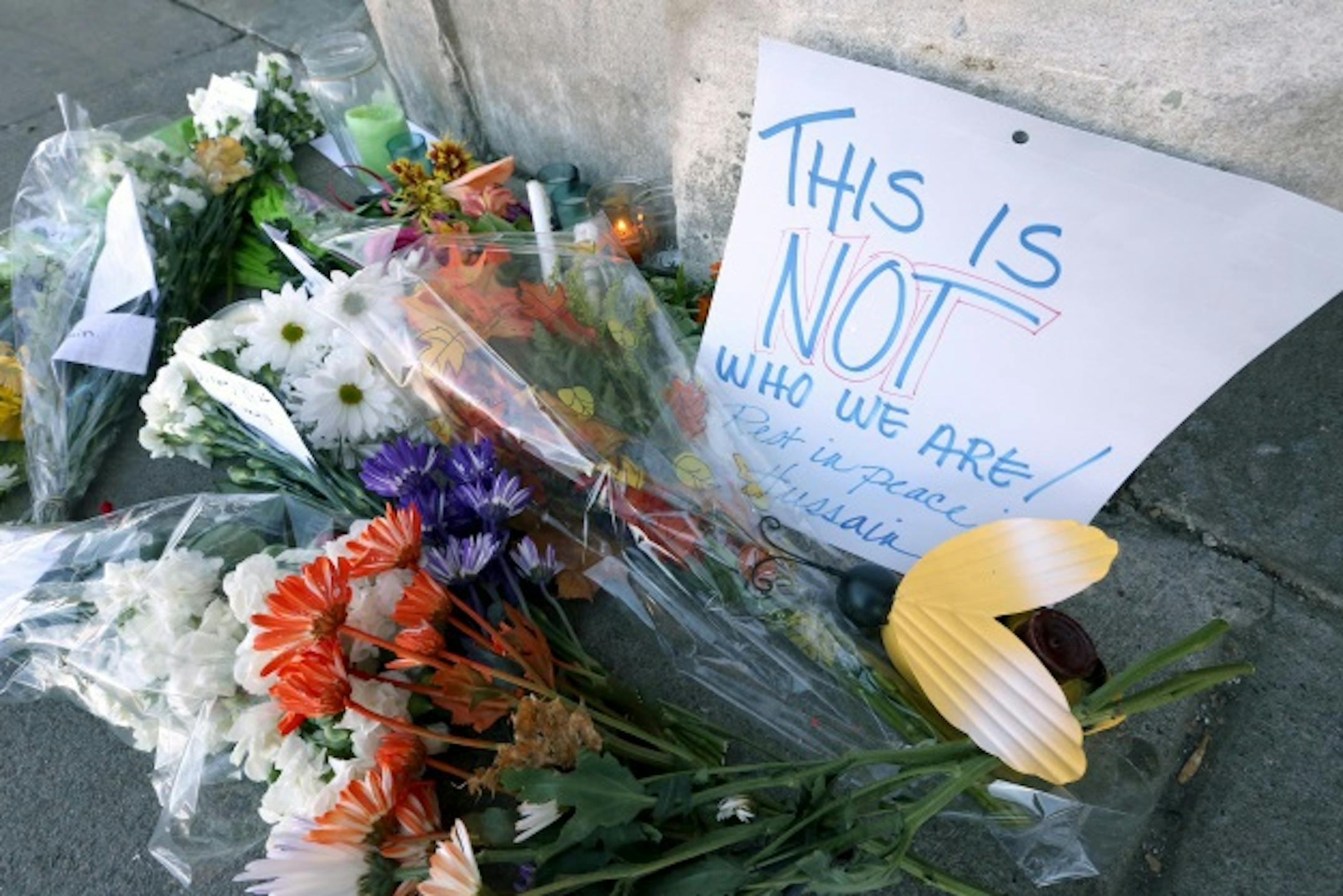 An emphatic message was left with flowers at the scene where Hussain Saeed Alnahdi was killed in downtown Menomonie, Wis.