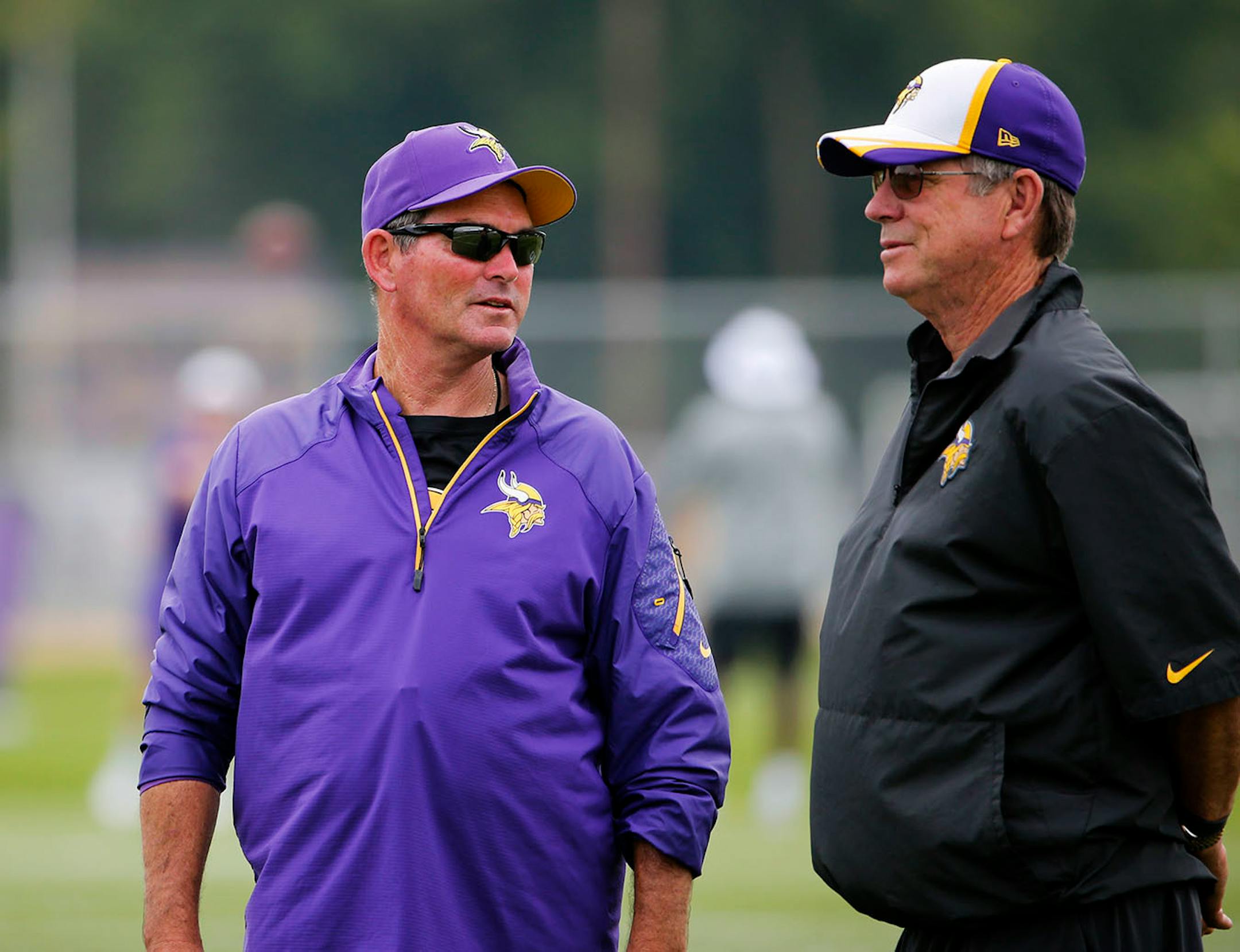 Minnesota Vikings head coach Mike Zimmer, left and offensive coordinator Norv Turner chat during the afternoon session of training camp Friday, July 24, 2014, at Minnesota State in Mankato, MN.