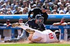 Cleveland catcher David Fry tags out the Twins' Alex Kirilloff at home plate during the first inning Saturday at Target Field.