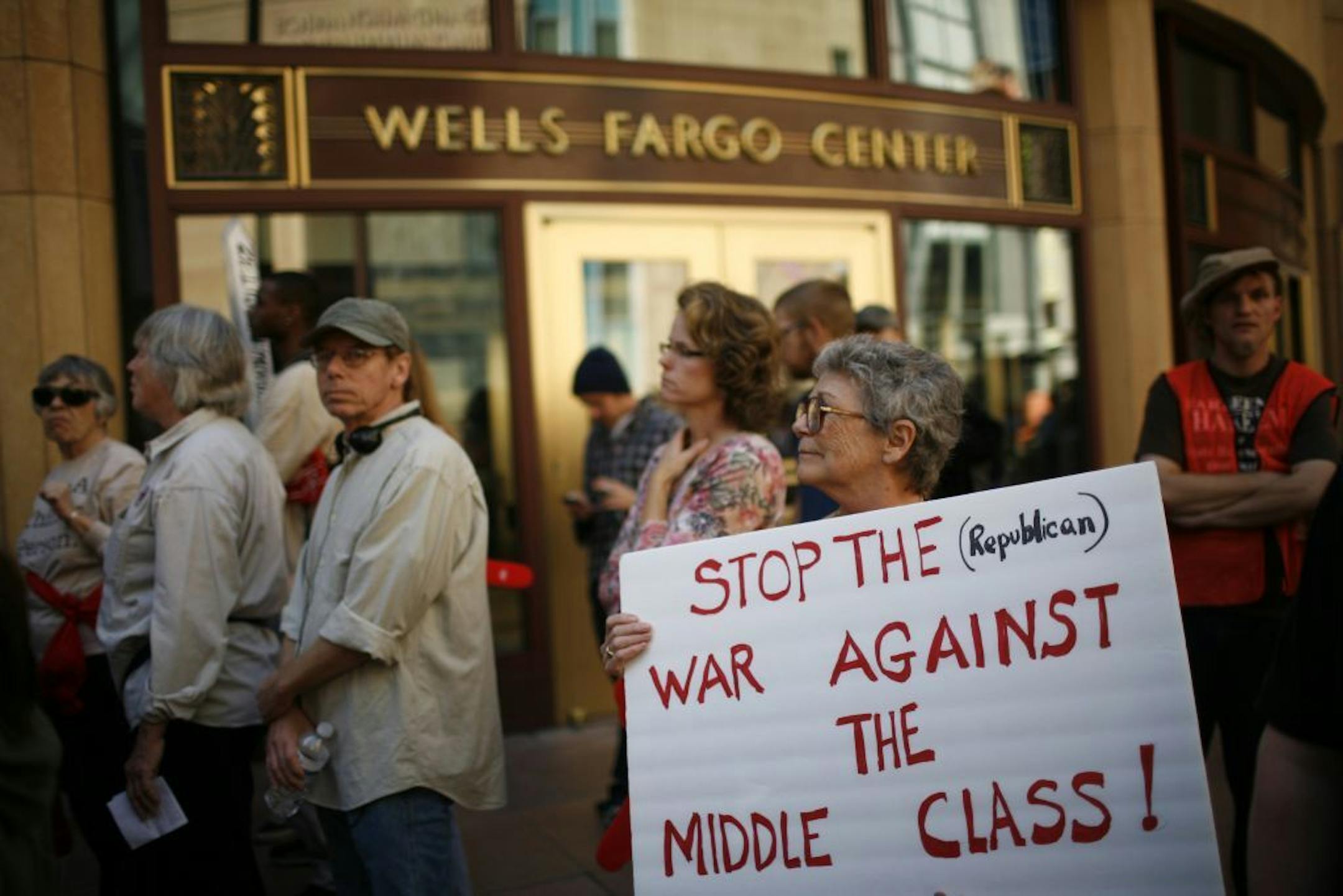 Faith Sullivan of northwest Minneapolis holds her sign in front of Wells Fargo bank on Tuesday, Oct. 11, 2011. Members from the OccupyMN and about two busloads of demonstrators including union members, retirees, and students,marched to Wells Fargo Bank in Minneapolis. (AP Photo/The Star Tribune, David Denney) MANDATORY CREDIT; ST. PAUL PIONEER PRESS OUT; MAGS OUT; TWIN CITIES TV OUT