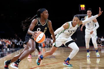 Las Vegas guard Jackie Young drives past Lynx forward Aerial Powers during Thursday's game.