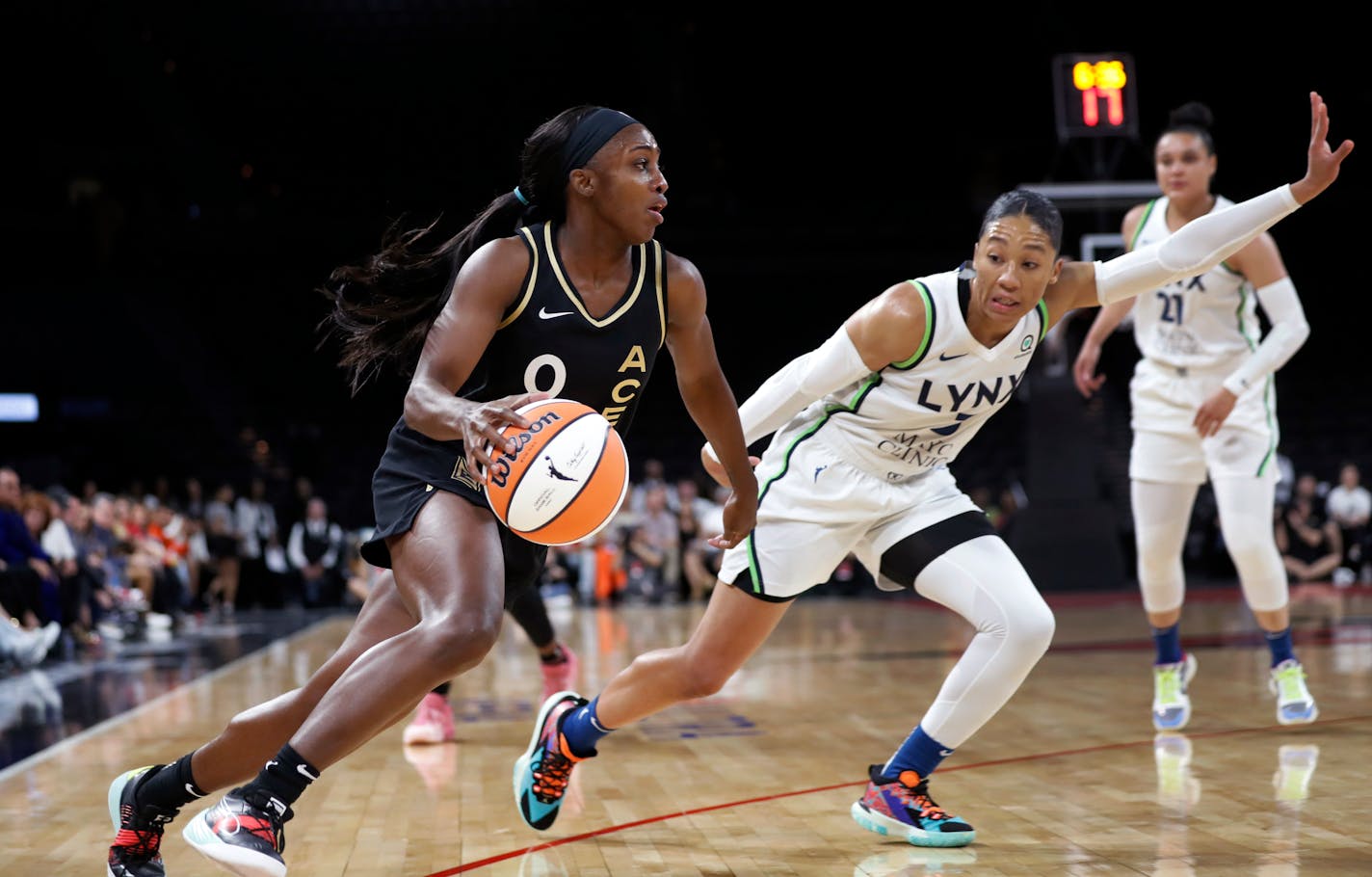 Las Vegas guard Jackie Young drives past Lynx forward Aerial Powers during Thursday's game.