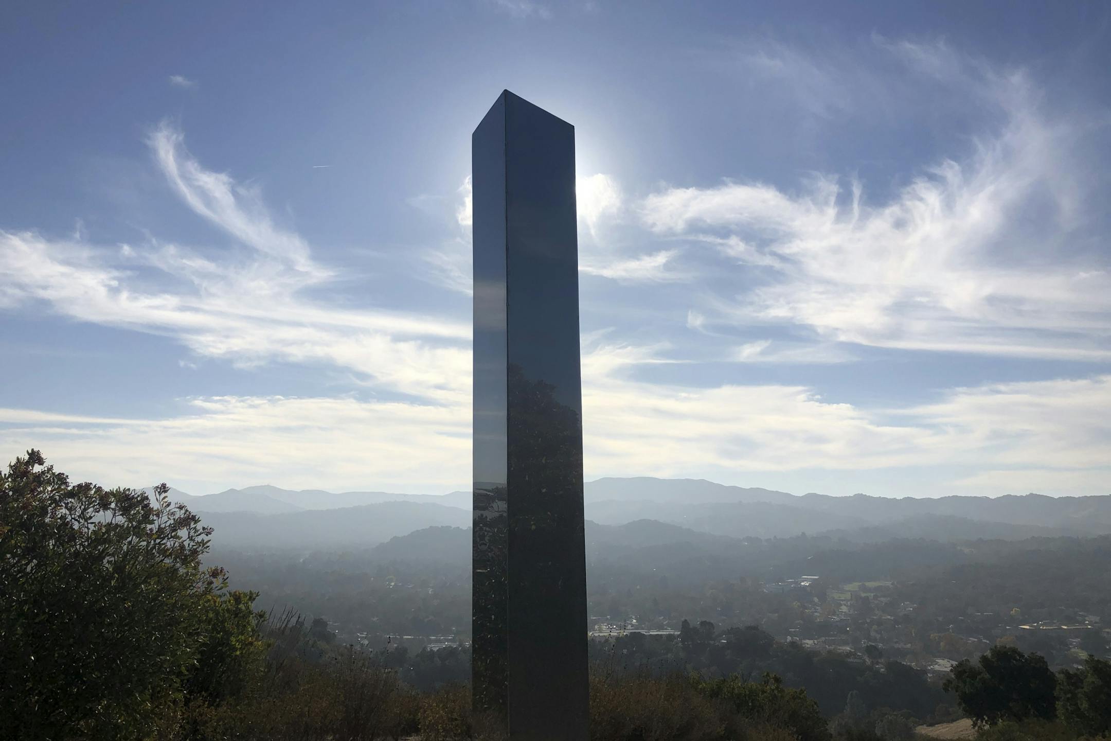 A monolith stands on a Stadium Park hillside in Atascadero, Calif., Tuesday, Dec. 2, 2020. Days after the discovery and swift disappearance of two shining metal monoliths half a world apart, another towering structure has popped up, this time at the pinnacle of a trail in Southern California. Its straight sides and height are similar to one discovered in the Utah desert and another found in Romania. (Kaytlyn Leslie/The Tribune
