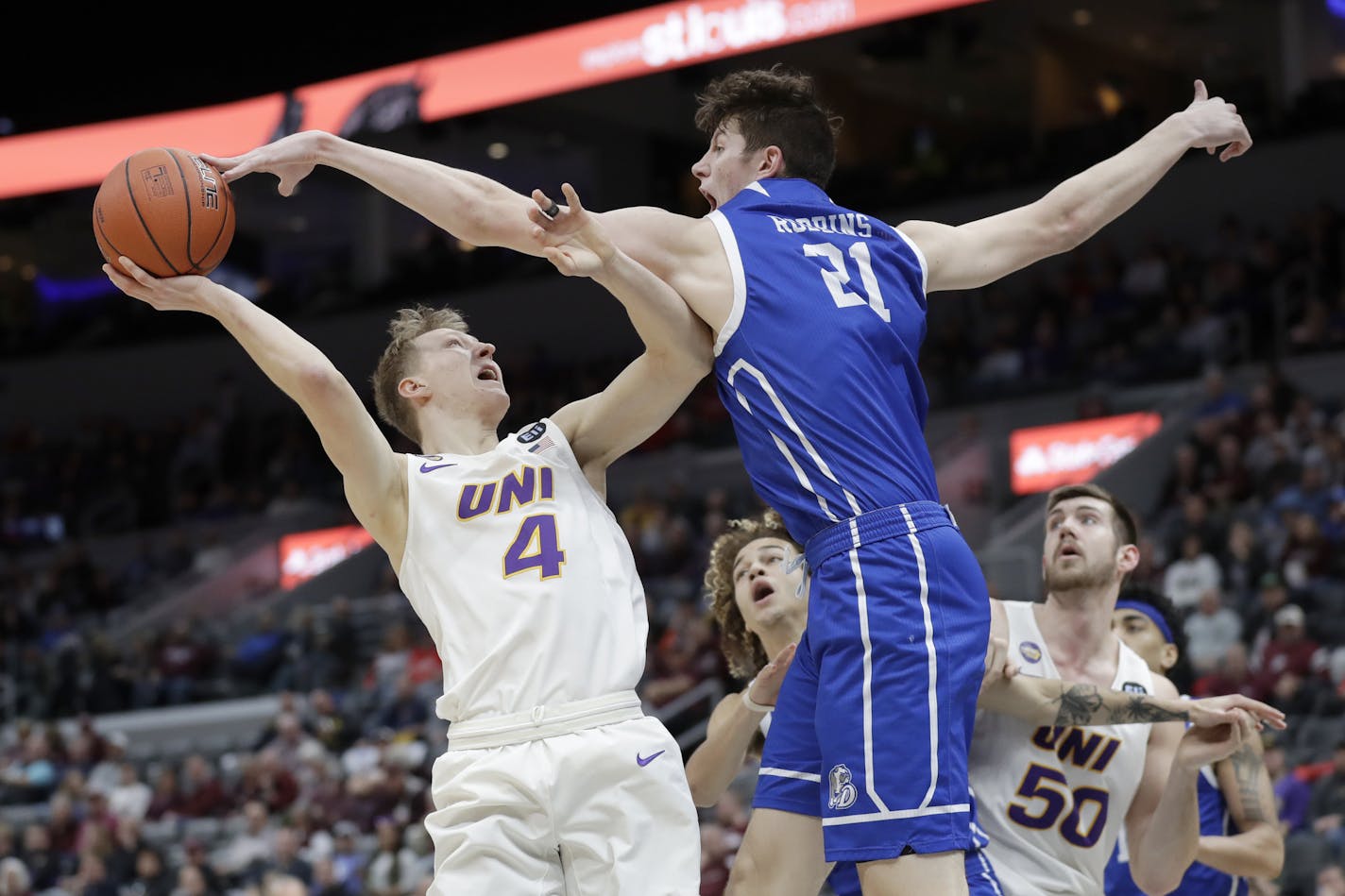 Northern Iowa's AJ Green (4) has his shot blocked by Drake's Liam Robbins (21) during the second half of an NCAA college basketball game in the quarterfinal round of the Missouri Valley Conference men's tournament Friday, March 6, 2020, in St. Louis. (AP Photo/Jeff Roberson) ORG XMIT: MOJR119