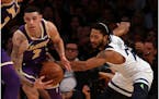 Lonzo Ball steals the ball from the Timberwolves' Derrick Rose in the first quarter Wednesday at Staples Center