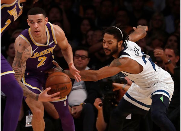 Lonzo Ball steals the ball from the Timberwolves' Derrick Rose in the first quarter Wednesday at Staples Center