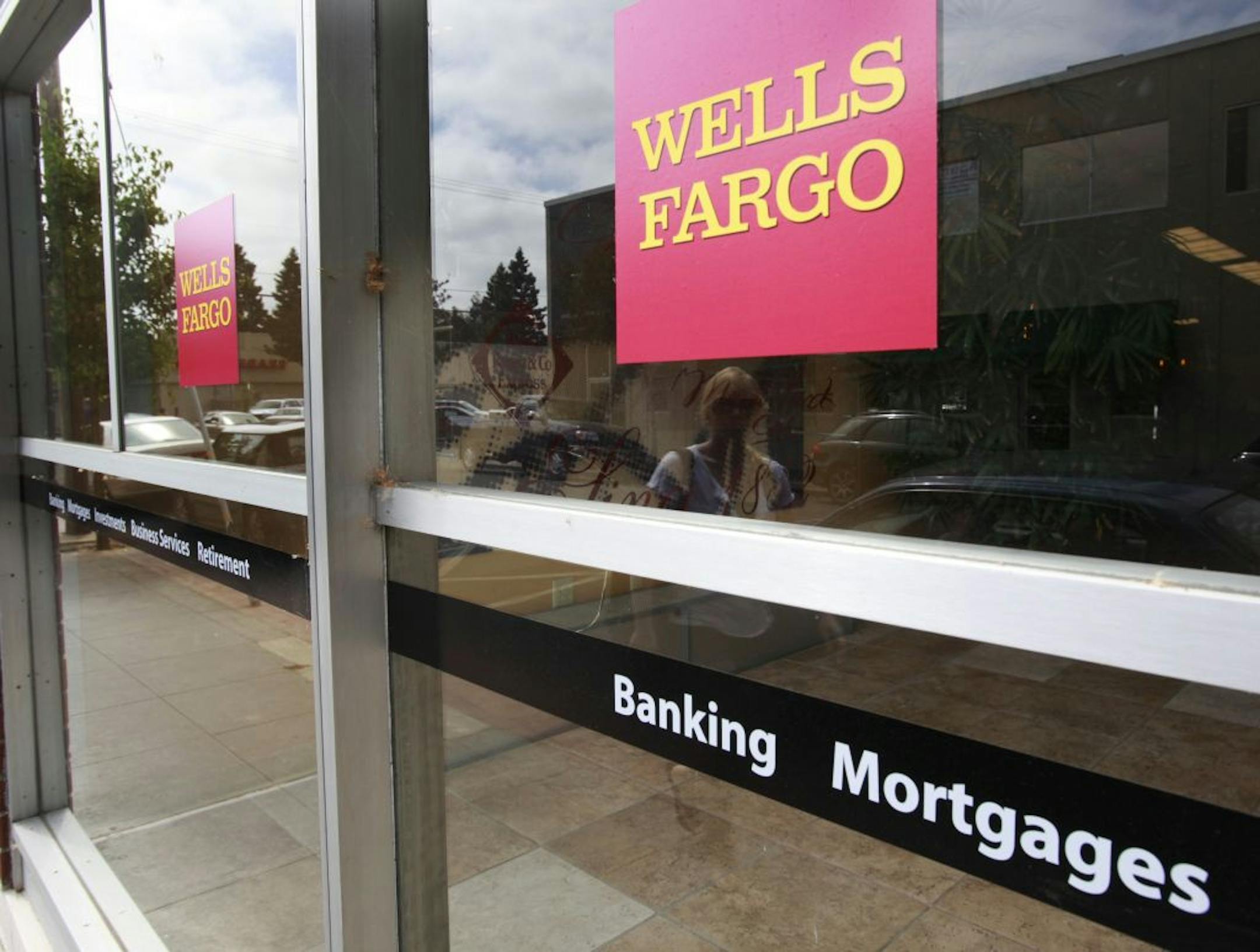 An advertisement for home mortgages is shown at a Wells Fargo Bank in Menlo Park, Calif., Thursday, July 8, 2010. Mortgage rates fell for the second straight week to the lowest point in five decades. But many people either don't qualify for new mortgages or have already taken advantage of the low rates this year.