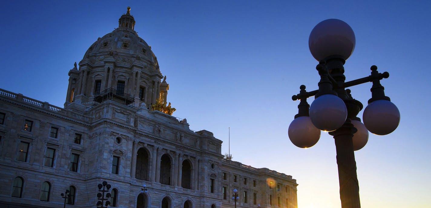 The sun rises behind the Minnesota State Capitol as lawmakers continued their work inside on Wednesday, May 24, 2017 in St. Paul, Minn. The Minnesota Legislature blew past a self-imposed 7 a.m. Wednesday deadline to finish work on a $46 billion budget. The House had several major votes remaining, and the Senate hadn&#xed;t taken any votes overnight as hope evaporated for a tidy wrapup to the five-month session. (Glen Stubbe/Star Tribune via AP) ORG XMIT: MIN2017052415565162