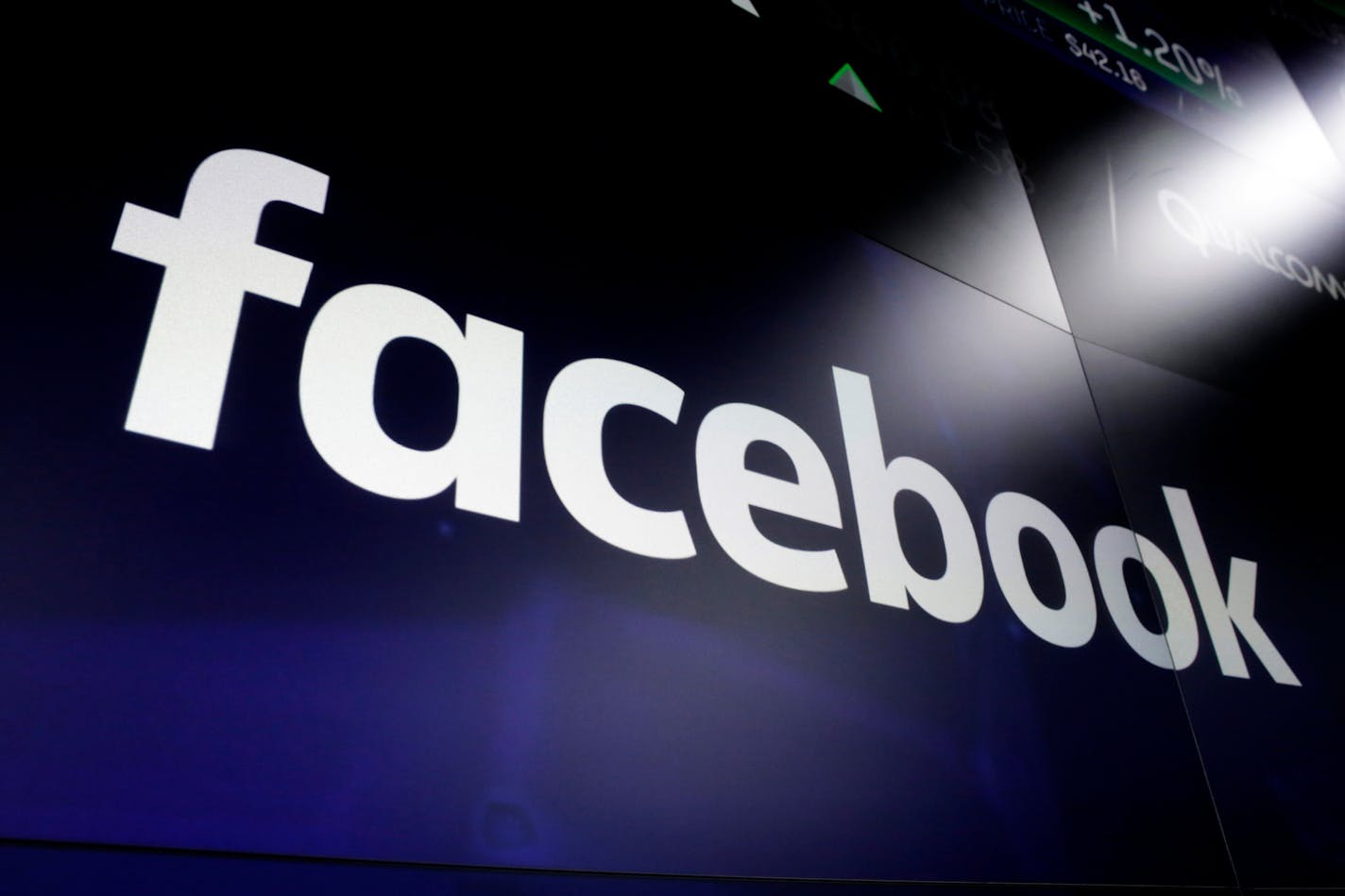 FILE - In this March 29, 2018 file photo shows the logo for Facebook at the Nasdaq MarketSite, in New York's Times Square. Facebook on Friday, Feb. 14, 2020, decided to allow a type of paid political message that sidesteps many of the social network's rules governing political ads. Its policy change comes days after presidential candidate Michael Bloomberg exploited a loophole to run such humorous messages promoting his campaign on the accounts of popular Instagram personalities followed by mill