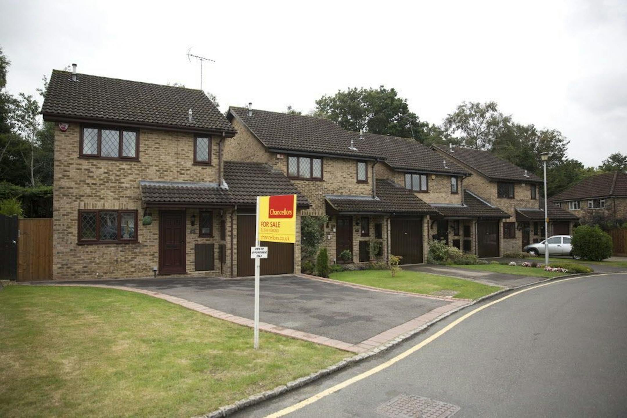 An exterior view shows at left, the house for sale that starred onscreen as Harry Potter's childhood home in the town of Bracknell, England, just over 30 miles (50 kms) west of central London, Tuesday, Sept. 20, 2016. Fans of the boy wizard will recognize it as the fictional address of 4 Privet Drive, home of Harry's dastardly aunt and uncle, the Dursleys, who made him sleep in a cupboard under the stairs. The 3-bedroom house is being sold by real estate agent Chancellors with an asking price of
