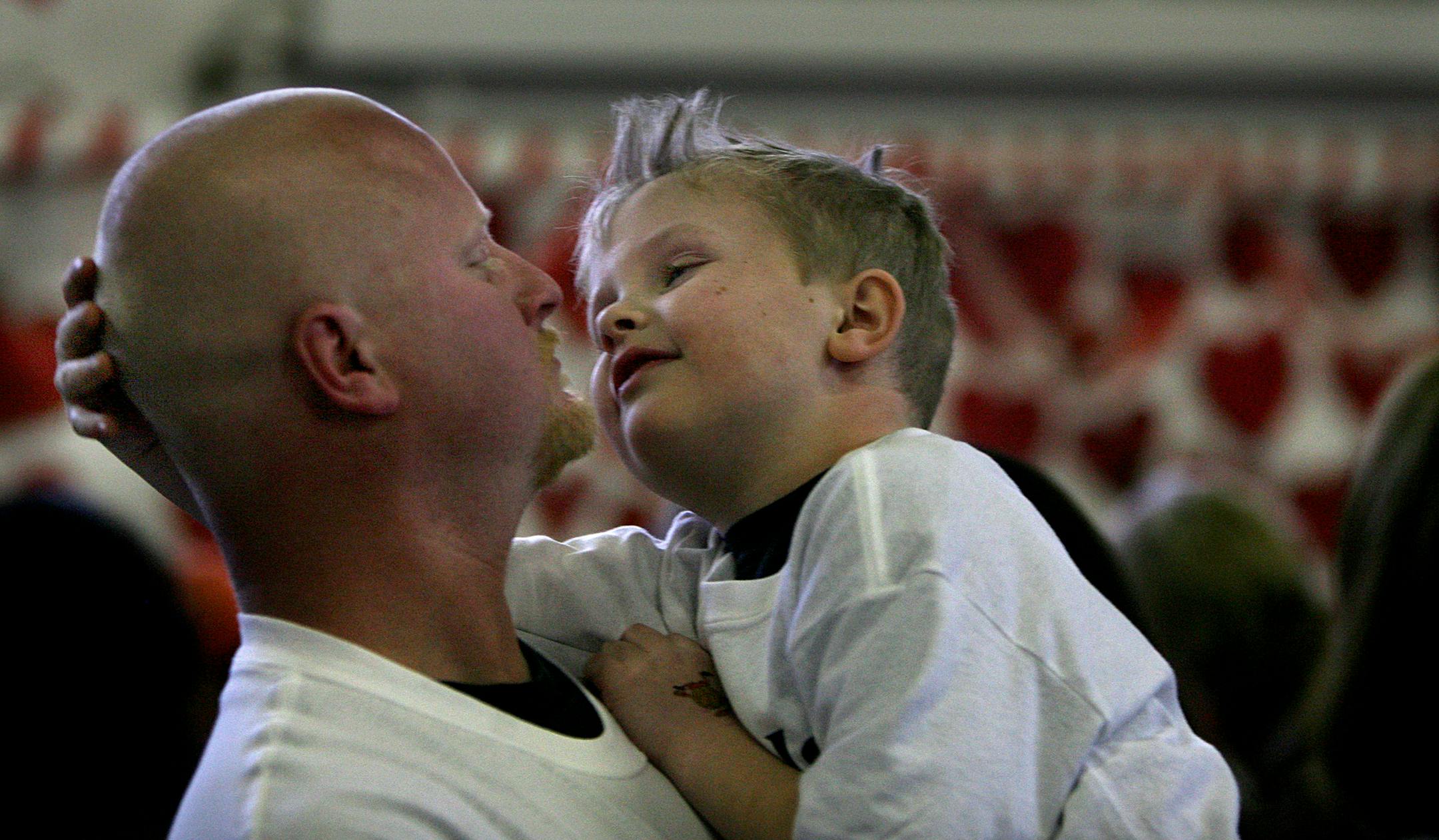 Fred Tilbury, a St. Helena School first-grader with brain cancer, felt the shaved head of his father, Dave. The school became an impromptu barber shop in support of Fred.