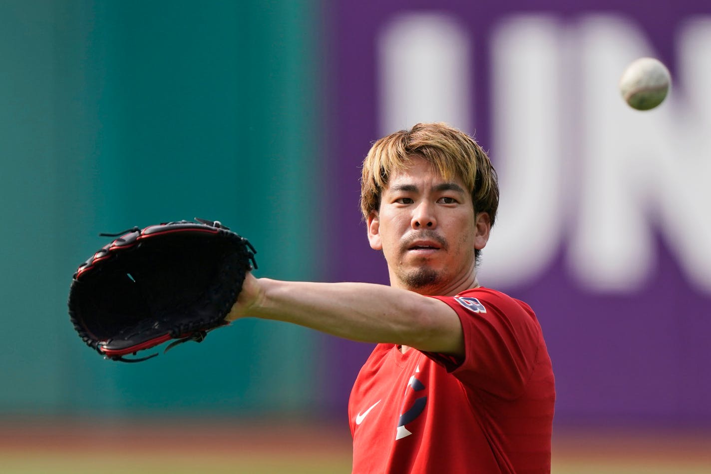 Minnesota Twins starting pitcher Kenta Maeda catches a ball during batting practice before a baseball game against the Cleveland Indians, Friday, May 21, 2021, in Cleveland. (AP Photo/Tony Dejak)