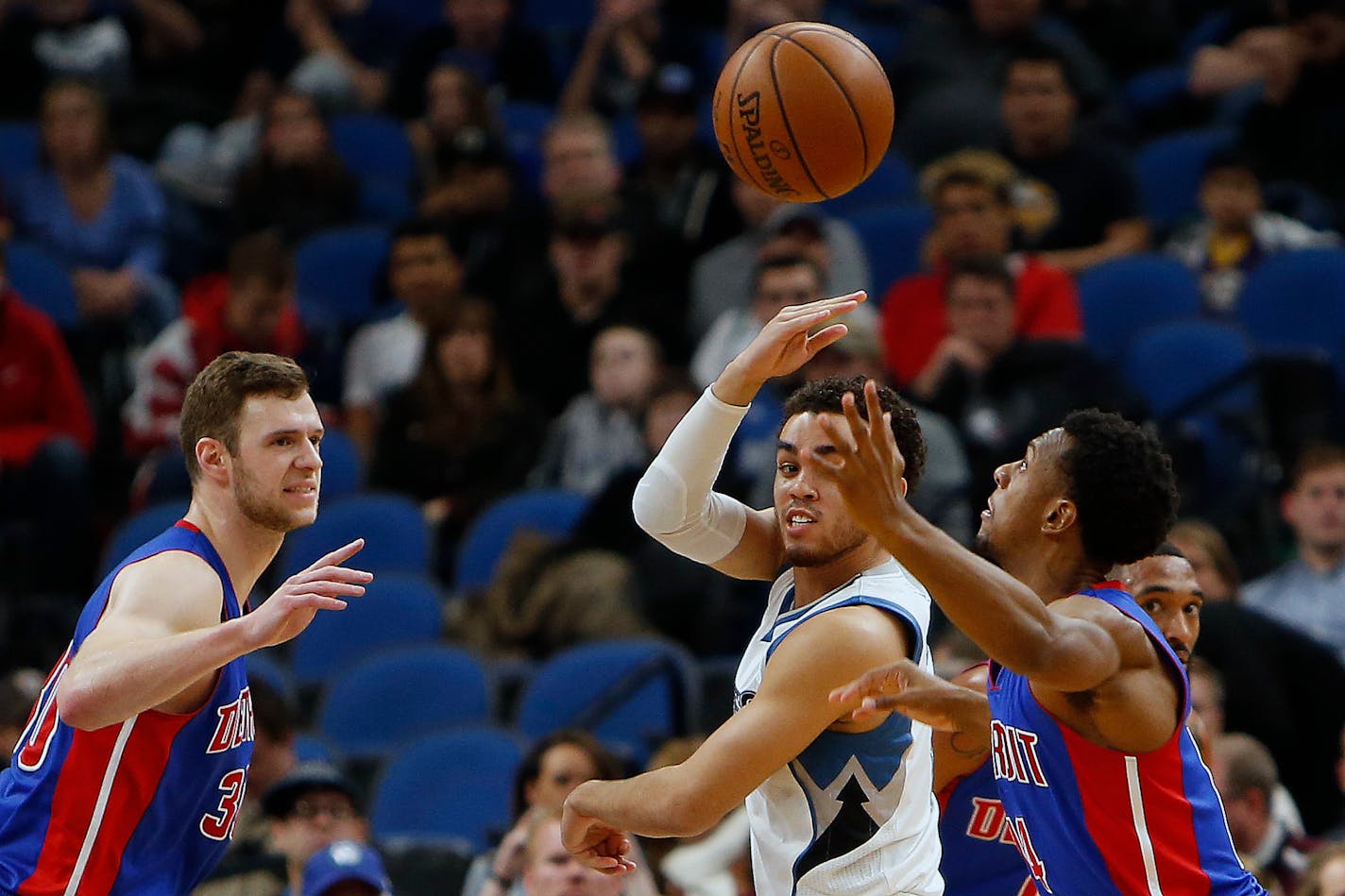 Minnesota Timberwolves guard Tyus Jones tries to pass the ball past Detroit Pistons guard Ish Smith last month.