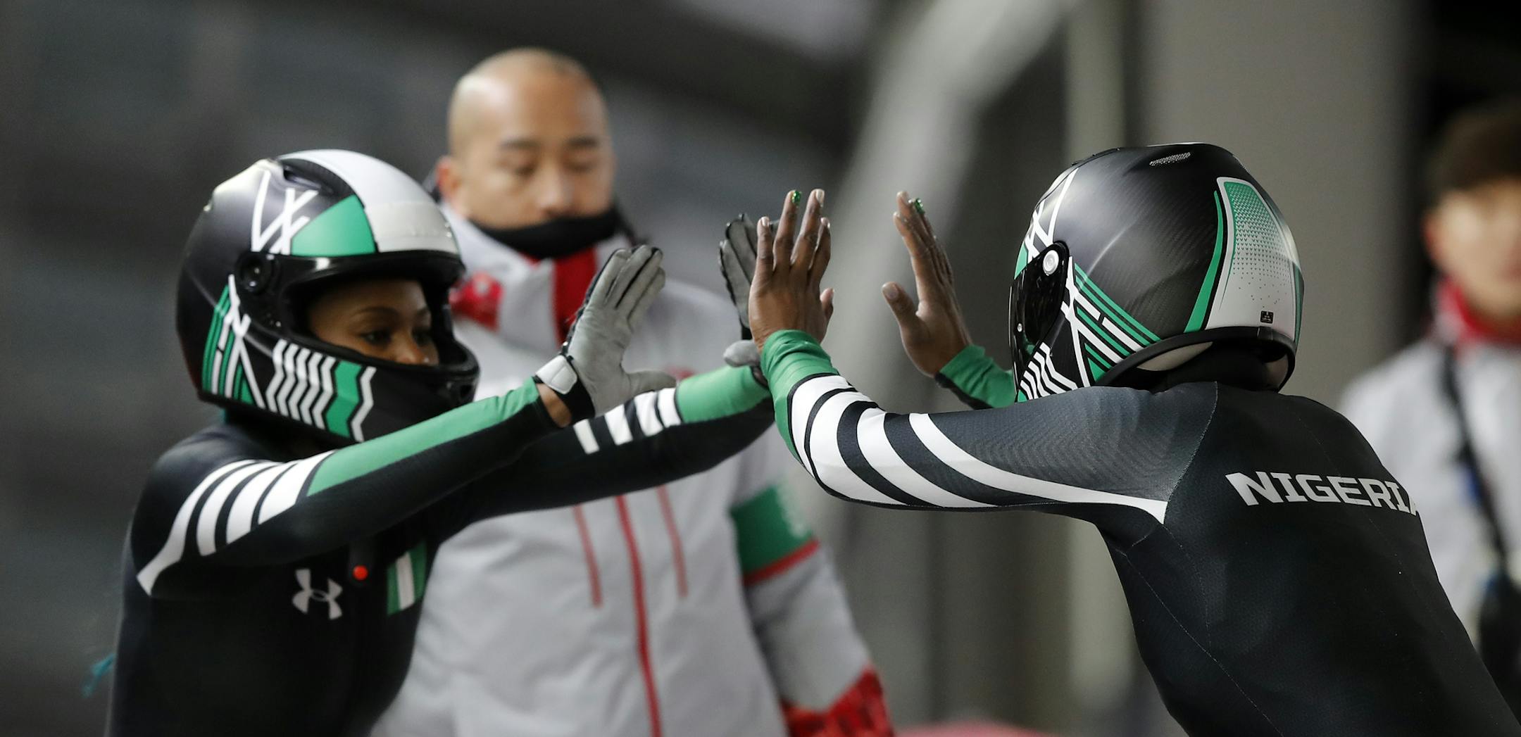 Driver Seun Adigun, right, and Akuoma Omeoga of Nigeria finish their second heat during the women's two-man bobsled competition at the 2018 Winter Olympics in Pyeongchang, South Korea, Tuesday, Feb. 20, 2018. (AP Photo/Andy Wong)