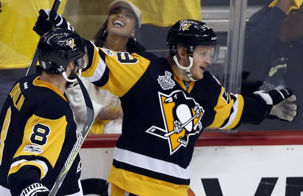 Pittsburgh Penguins' Jake Guentzel (59) celebrates his goal against the Nashville Predators with Brian Dumoulin (8) during the third period in Game 2 
