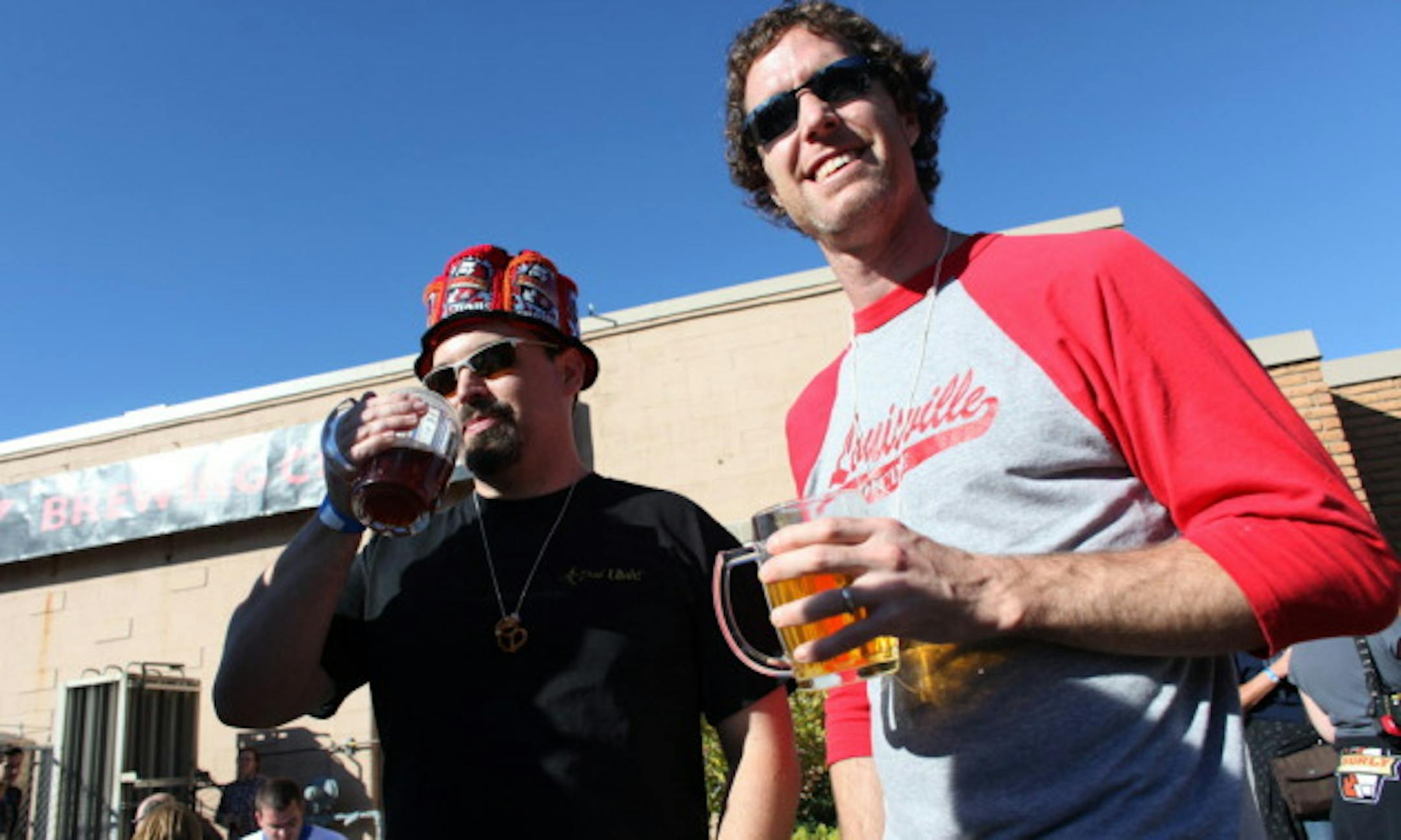 KYNDELL HARKNESS ' kyndell.harkness@startribune.com  BROOKLYN CENTER 9/18/10   Surly festival.  IN THIS PHOTO : ]   Scott Bennett , left and his brother Ryan enjoy beer and sunshine during the annual SurlyFest at their brewery. Scott is from California and came to Minnesota for the event.