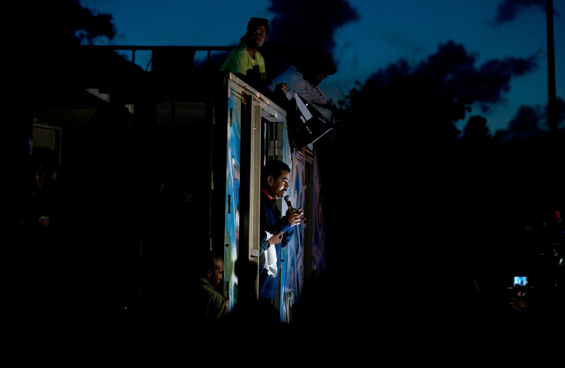 In this Wednesday, Dec. 9, 2015 photo, Venezuela's President Nicolas Maduro addresses supporters from a trailer truck outside Miraflores presidential palace in Caracas, Venezuela. Maduro promised to protect the country's socialist revolution from what he says are "bad guy" opposition leaders who will take control of Congress next month. (AP Photo/Fernando Llano)