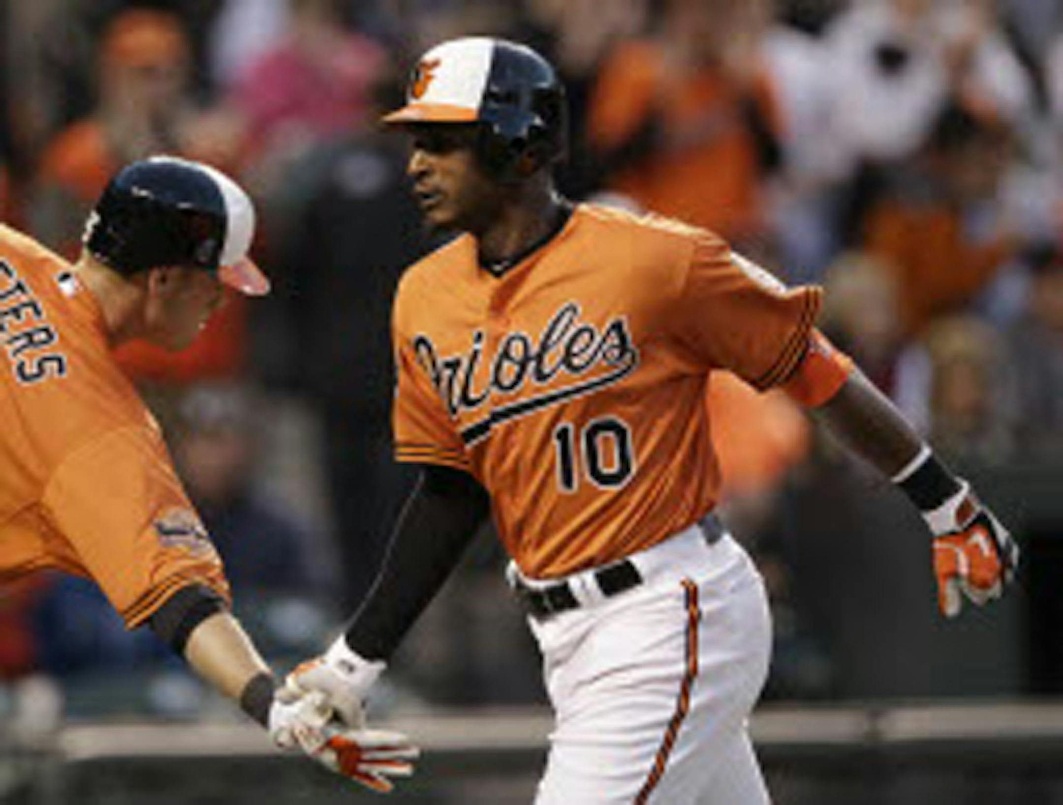 The Orioles' Adam Jones (10) met teammate Matt Wieters as he crossed home plate after hitting a solo home run in the second inning of an 8-2 victory over the Twins on Saturday.