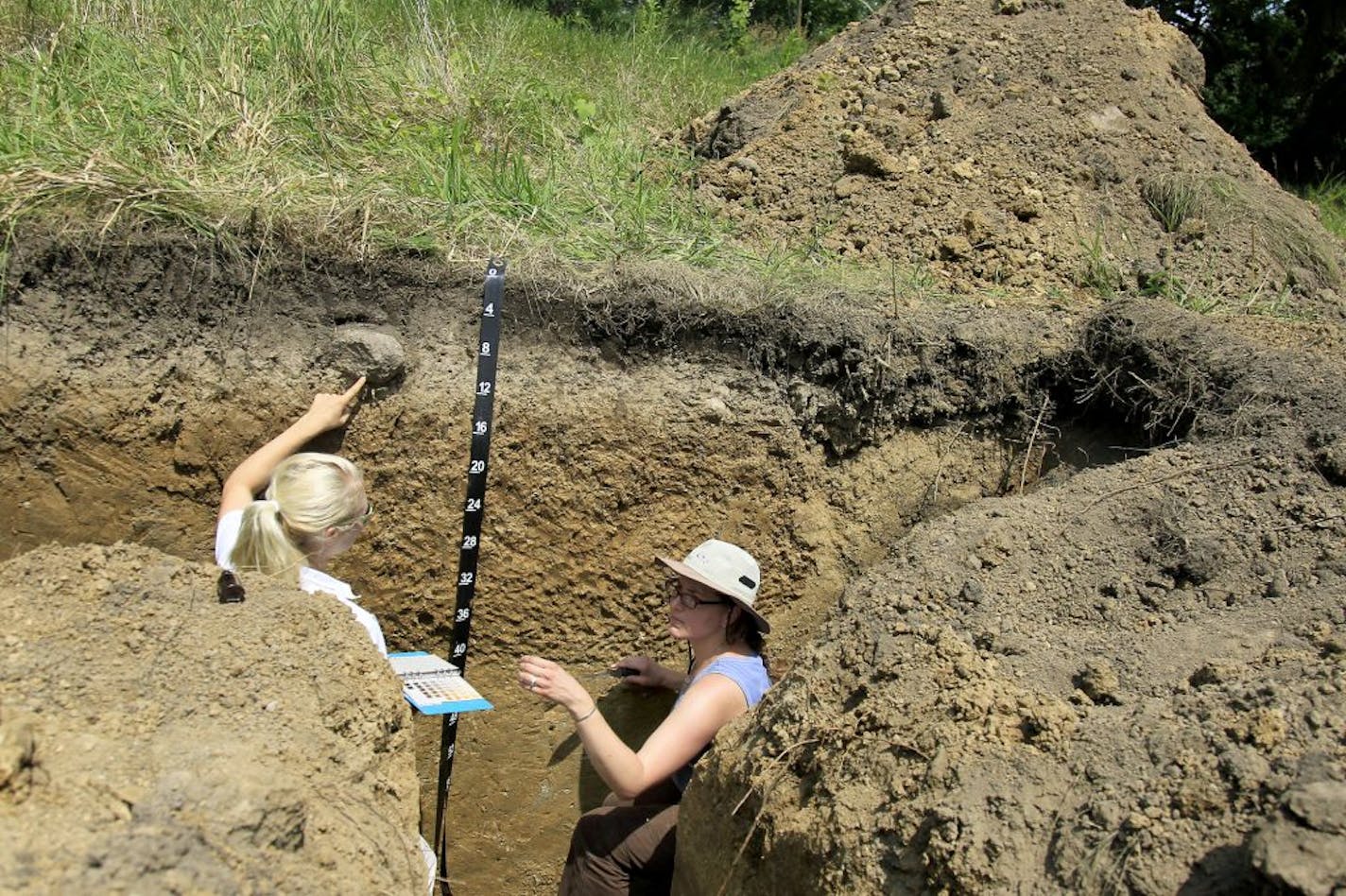 Soil scientists Janine Anderson, left, and Kristin Brennan took soil samples from a dig site at Gale Woods Farm that shows the different layers of soil and specifically the Lester Soil, Wednesday, July 25, 2012. Lester Soil has been designated by the legislature as the �official� state soil. Gale Woods Farm is the home of Lester Soil. (ELIZABETH FLORES/STAR TRIBUNE) ELIZABETH FLORES � eflores@startribune.com