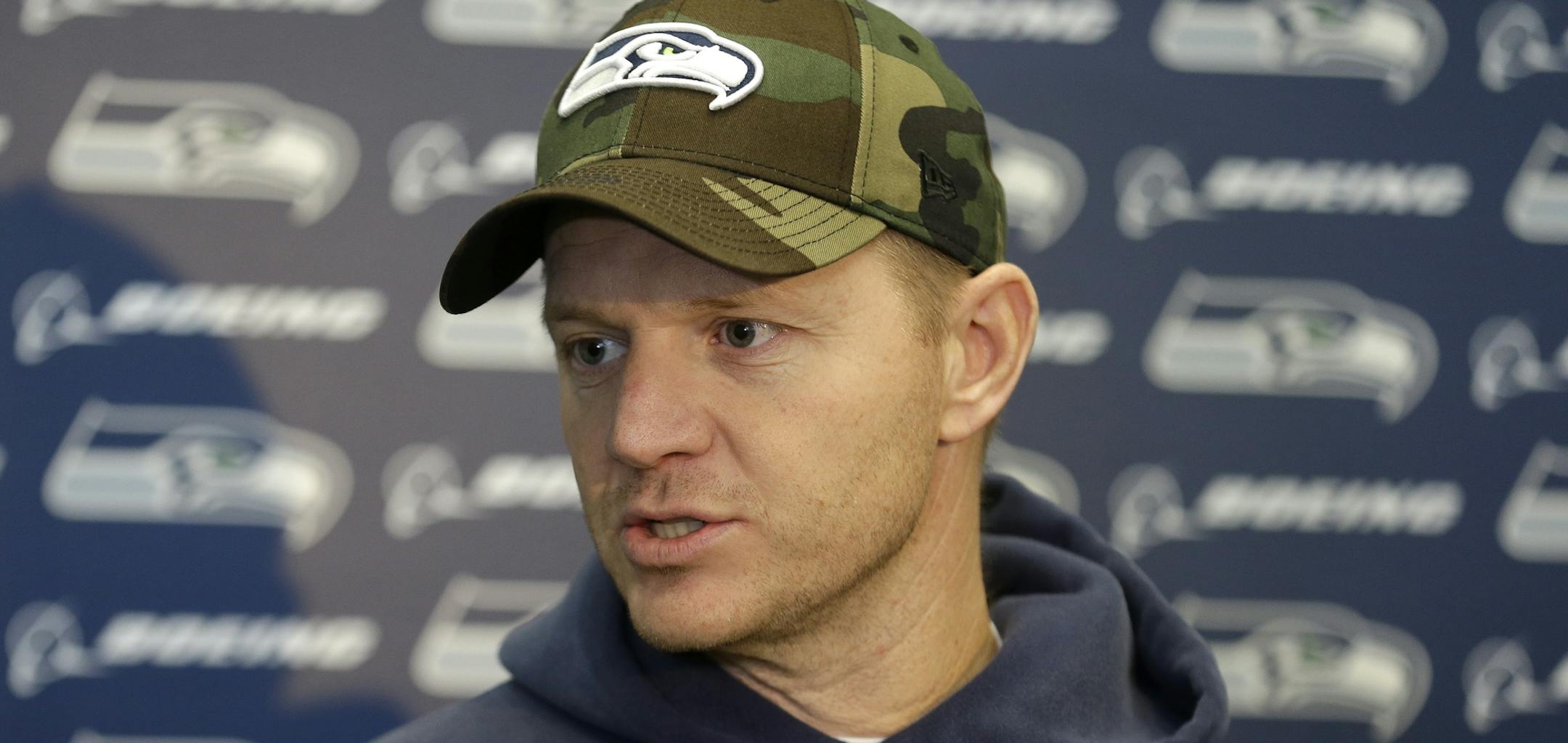 Seattle Seahawks offensive coordinator Darrell Bevell talks to reporters on Wednesday, Jan. 15, 2014, after NFL football practice in Renton, Wash. The Seahawks are to play the San Francisco 49ers on Sunday in the NFC championship. (AP Photo/Ted S. Warren) ORG XMIT: MIN2014011617032072