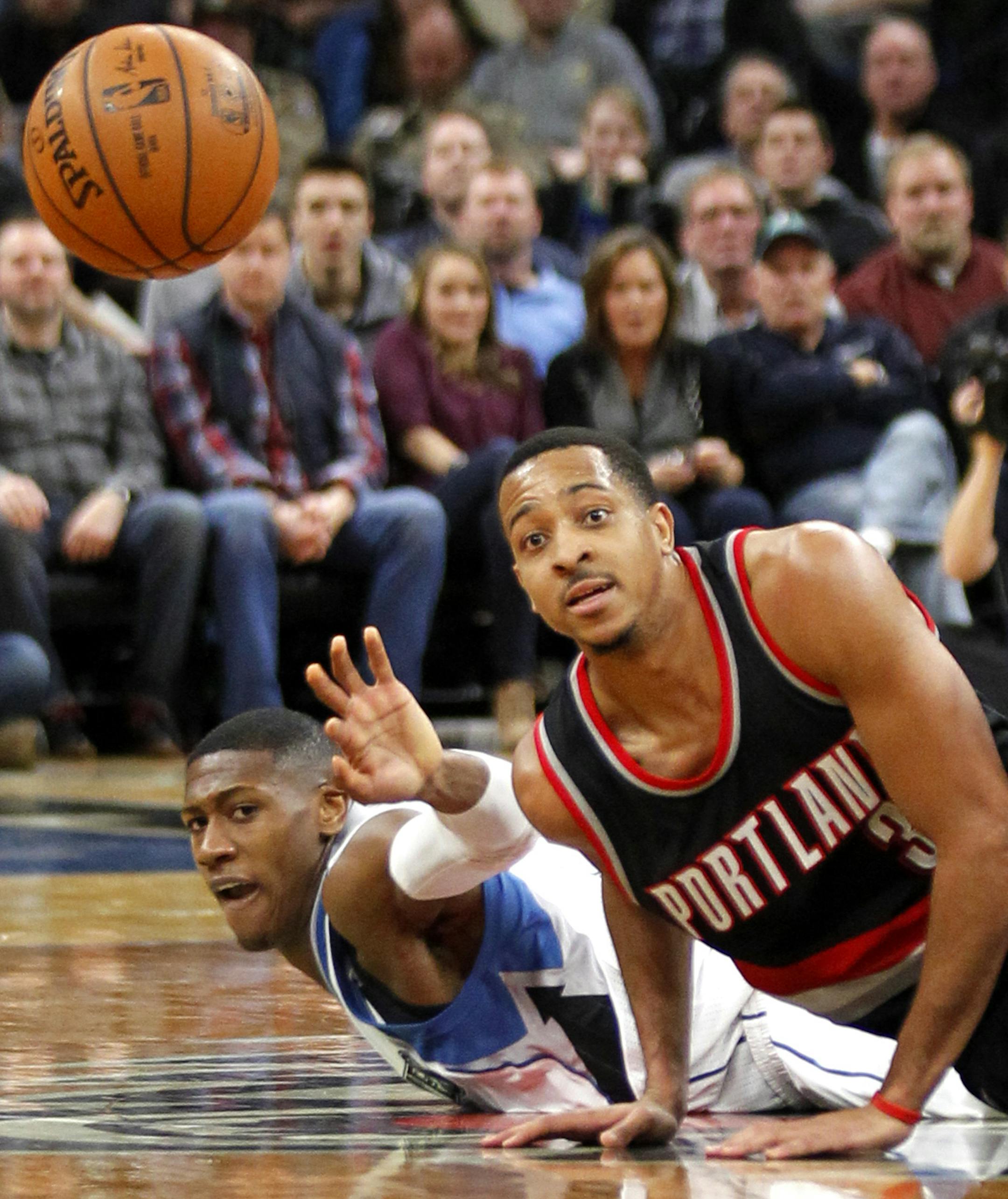 Portland Trail Blazers guard C.J. McCollum (3) and Minnesota Timberwolves guard Chris Dunn (3) vie for for the ball during the third quarter of an NBA basketball in Minneapolis, Sunday, Jan. 1, 2017. The Trail Blazers defeated the Timberwolves 95-89. (AP Photo/Andy Clayton-King)