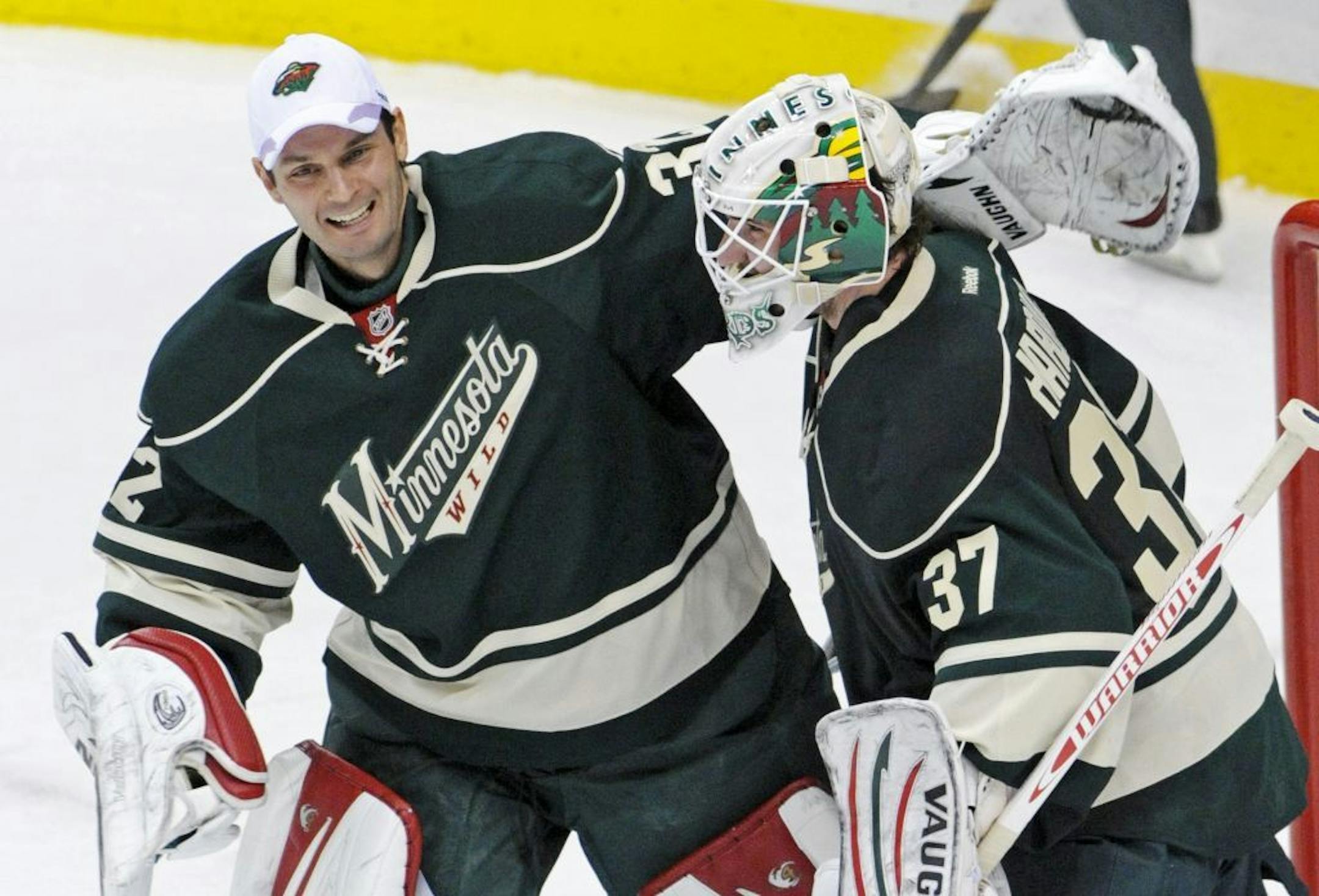 Niklas Backstrom, left, congratulates fellow goalie Josh Harding after Saturday's victory over Detroit at the X.