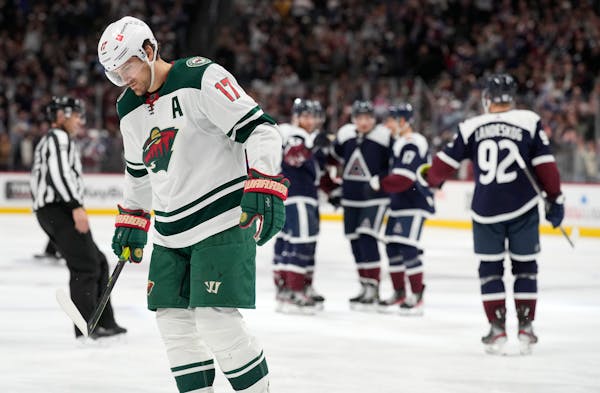 Wild winger Marcus Foligno skated away as Avalanche players celebrate a goal by center Nazem Kadri during the third period Saturday night in Denver.