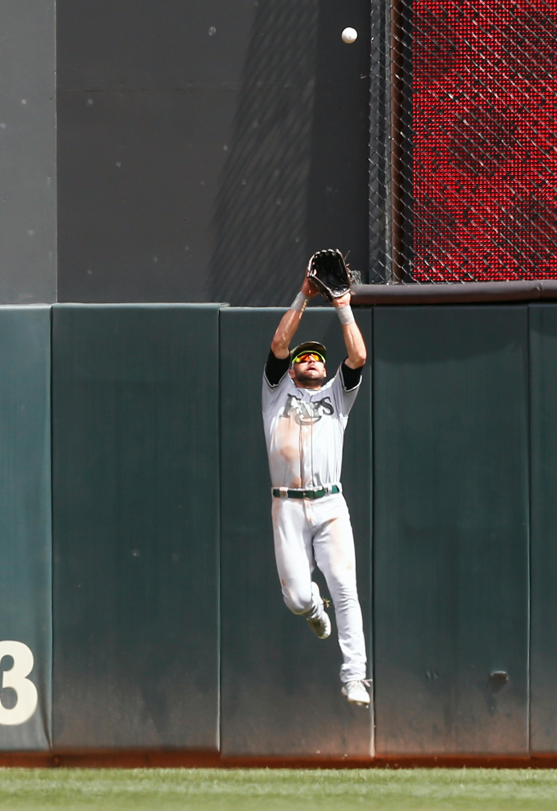 Tampa Bay Rays center fielder Kevin Kiermaier leaps to catch a deep fly ball off the bat of Minnesota Twins' Max Kepler in the fourth inning of a baseball game Sunday, May 28, 2017 in Minneapolis. (AP Photo/Jim Mone)