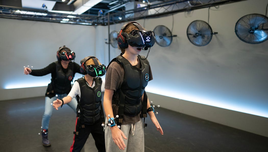 Christine Sullivan, back left, and her kids Dublin and Callahan played virtual reality games at Sandbox VR at Rosedale Center on November 12, 2023 in Rosedale. 