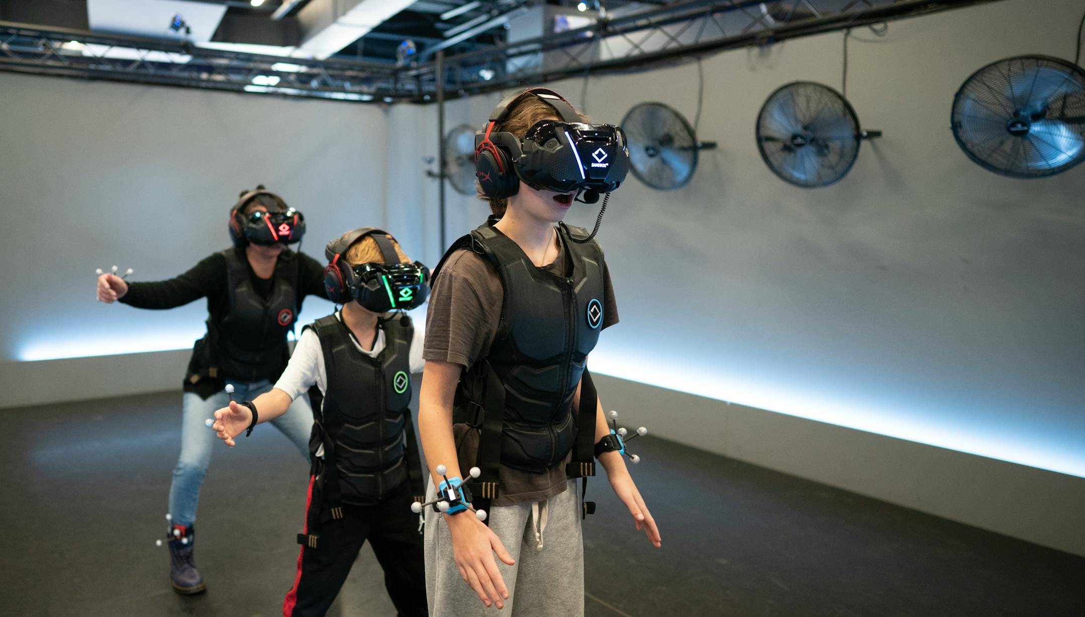 Christine Sullivan, back left, and her kids Dublin, and Callahan played virtual reality games at Sandbox VR at Rosedale Center Sunday November 12,2023 in, Minn. ] JERRY HOLT • jerry.holt@startribune.com