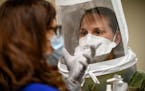 Occupational health nurse Kit Bielenberg, left, worked with U.S. Air Force Capt. Aimee Clonts during an N95 mask fitting Tuesday at Hennepin County Me