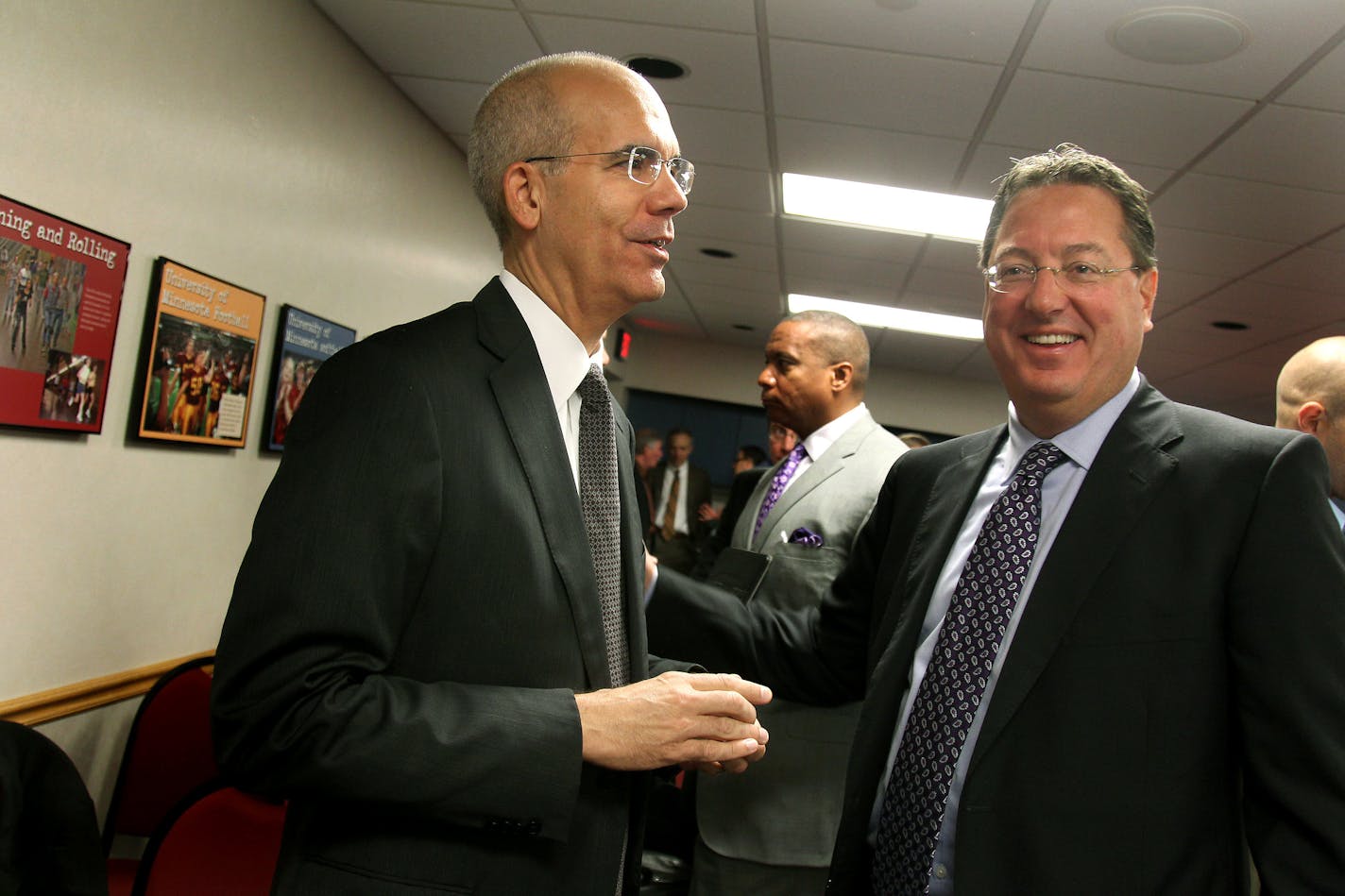 Bryan Trubey of HKS Sports & Entertainment Group, left, was greeted by Vikings Vice President Lester Bagley after the announcement was made that HKS will be the architectural firm designing the new stadium, Friday, September 28, 2012. The Minnesota Sports Facilities Authority Five national firms were competing for a job that will pay $30 million to $50 million.(ELIZABETH FLORES/STAR TRIBUNE) ELIZABETH FLORES � eflores@startribune.com