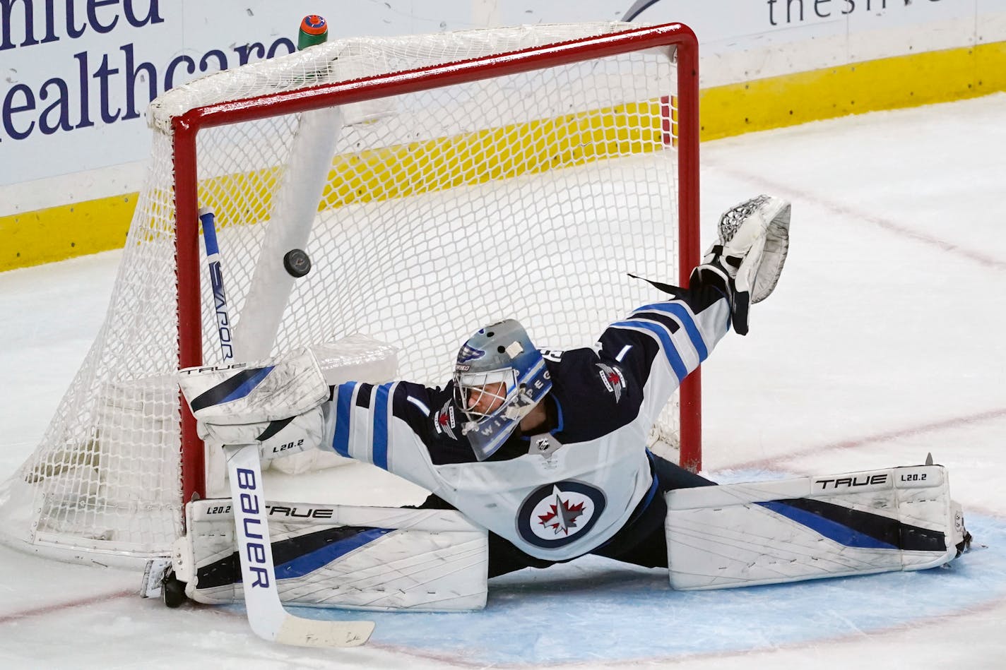 Jets goalie Eric Comrie gives up a goal to the Wild's Matt Dumba in the third period Friday.