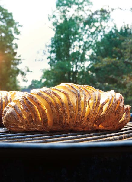 Credit: Tim Turner Hasselback Potatoes With Garlic Butter and Parmesan, from "Weber's New American Barbecue Bible."