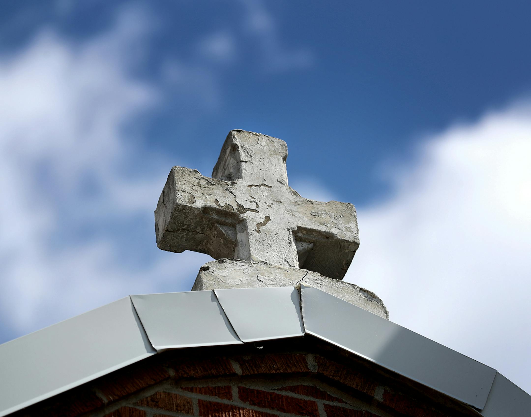 A cross atop the exterior of Poor Clare Nuns of St. Clare's Monastery Chapel Thursday, April 16, 2020, in Sauk Rapids, MN.Poor Clare nuns of St. Clare's Monastery nuns met with journalists in the monastery's parlor, the one room where outsiders have partial access to the nuns in a room divided by a metal lattice with a folding wooden divider.