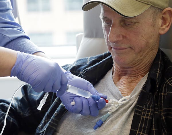 In this photo taken March 21, 2017, lymphoma patient Peter Bjazevich receives cellular immunotherapy as part of a study at the Fred Hutchinson Cancer 