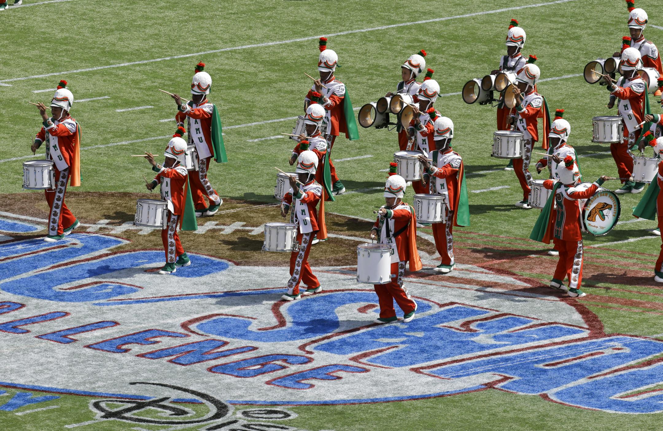 The Florida A&M University band performs at half time Sunday, Sept. 1, 2013, in Orlando, Fla., during FAMUís season-opening football game against Mississippi Valley State, its first appearance in a football stadium in nearly 22 months after the 2011 hazing death of a drum major. All band performances were halted for FAMU's famed Marching 100 shortly after Robert Champion collapsed and died following a hazing ritual on a bus parked at an Orlando hotel in November 2011. (AP Photo/John Raoux)